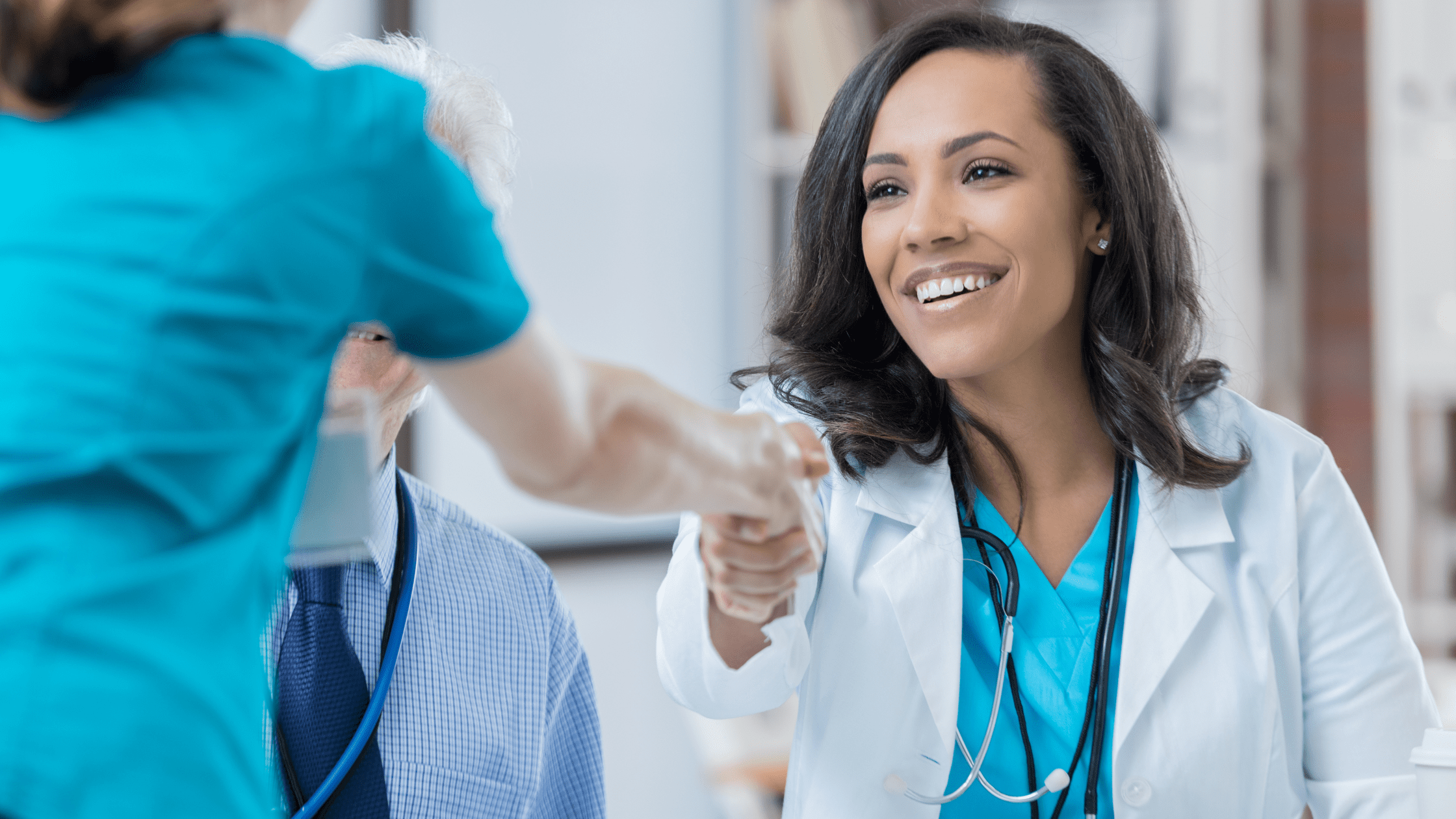 A doctor shaking hands with a prospective resident at their residency interview.